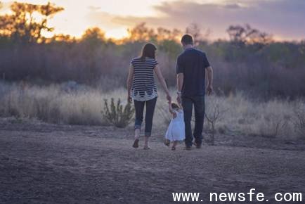 Man, Woman, and Girl Walking during Sunset